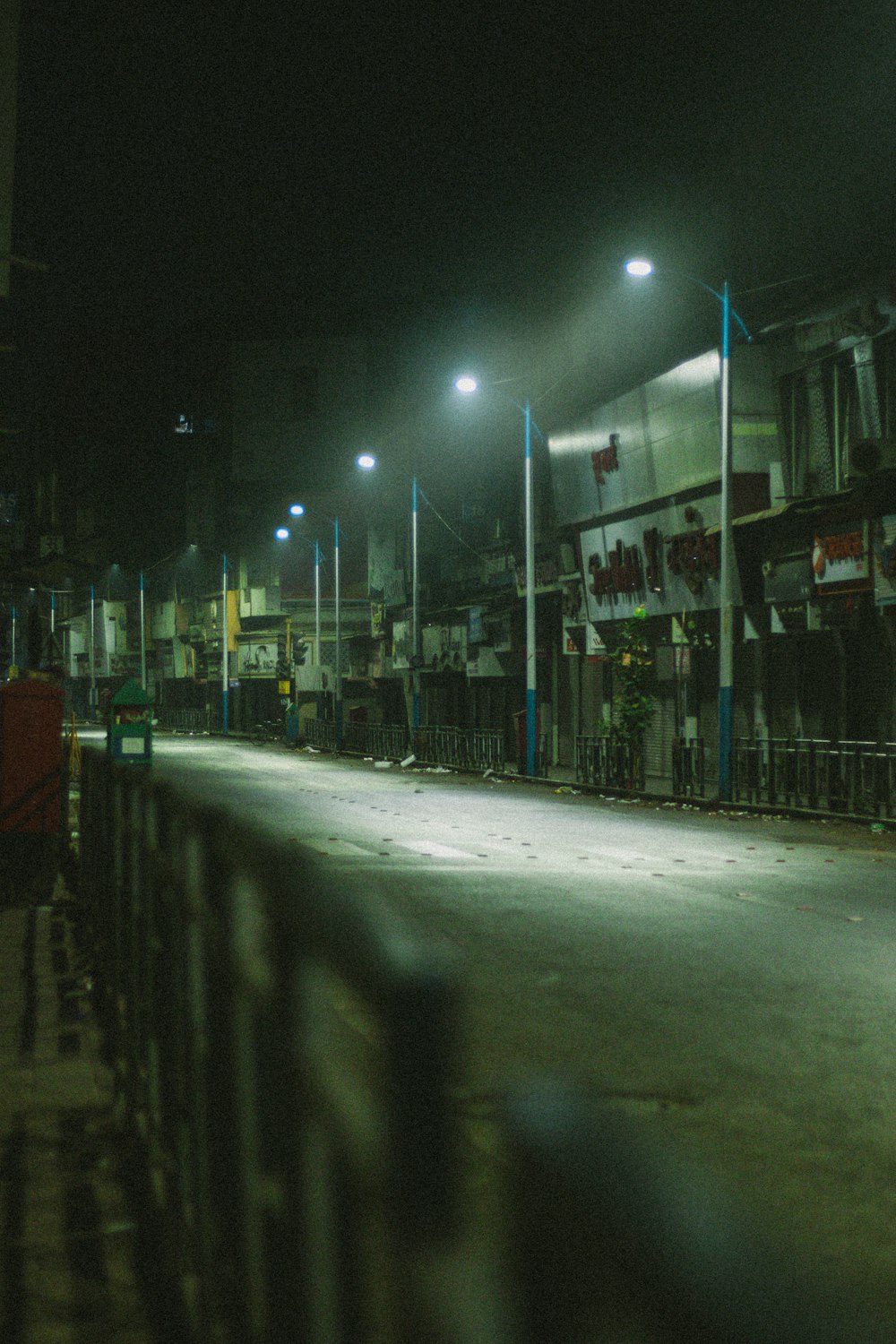 an empty street at night with street lights
