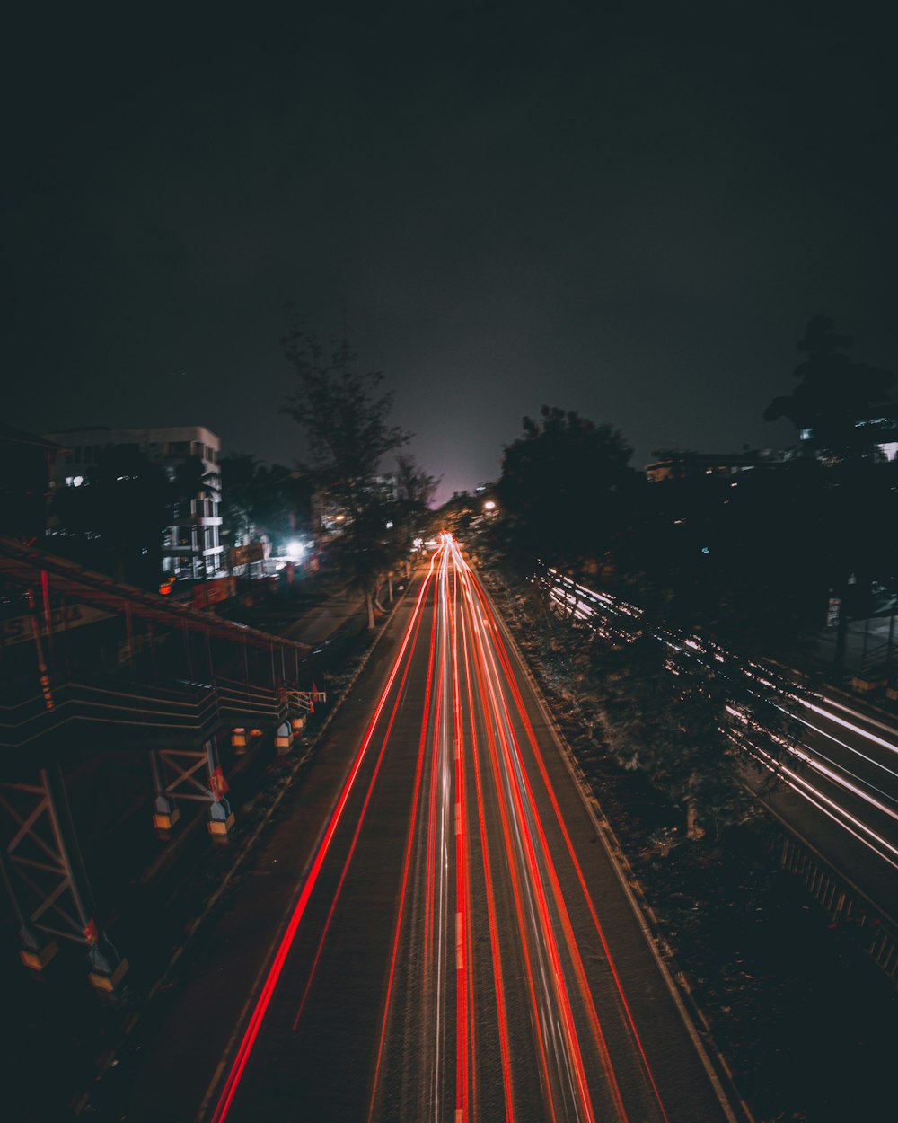 a long exposure photo of a city street at night