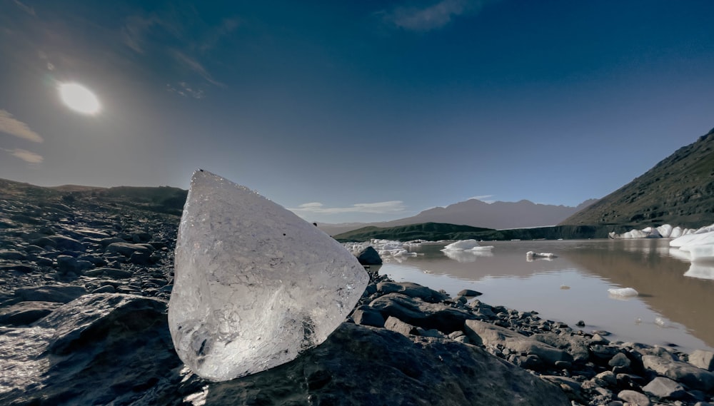 a large rock sitting on top of a rocky beach