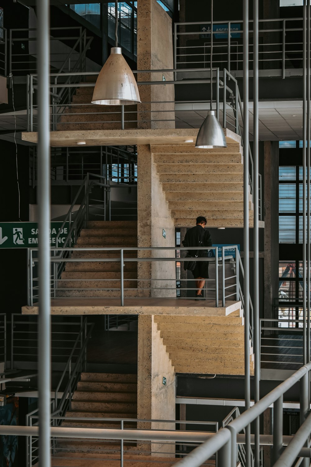 a man is standing on the stairs of a building