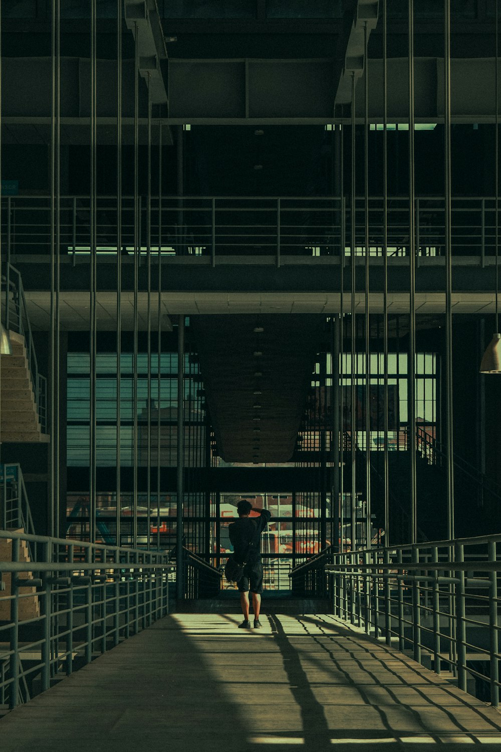 a person walking down a walkway in a building