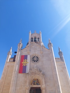 a tall building with a flag on the front of it