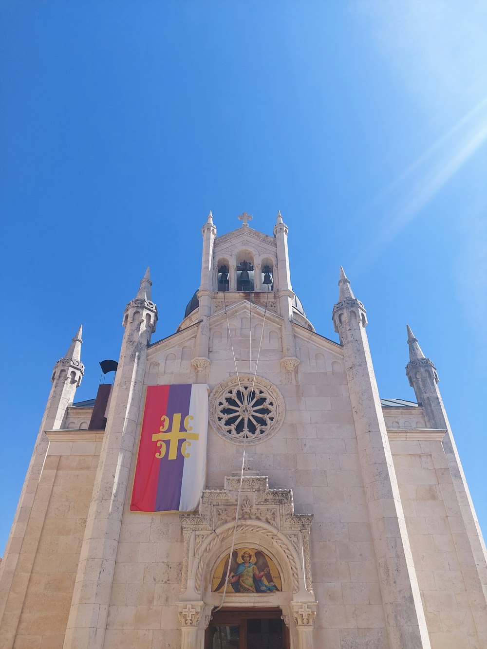 a tall building with a flag on the front of it