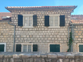 Cozy traditional Georgian house with stone walls and wooden shutters in Tskaltubo.