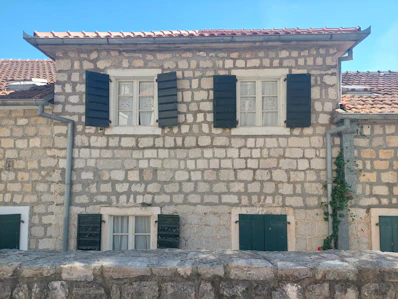 Cozy traditional Georgian house with stone walls and wooden shutters in Tskaltubo.