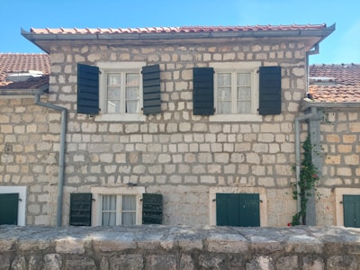 Traditional stone houses with colorful shutters in a quaint village of Menorca