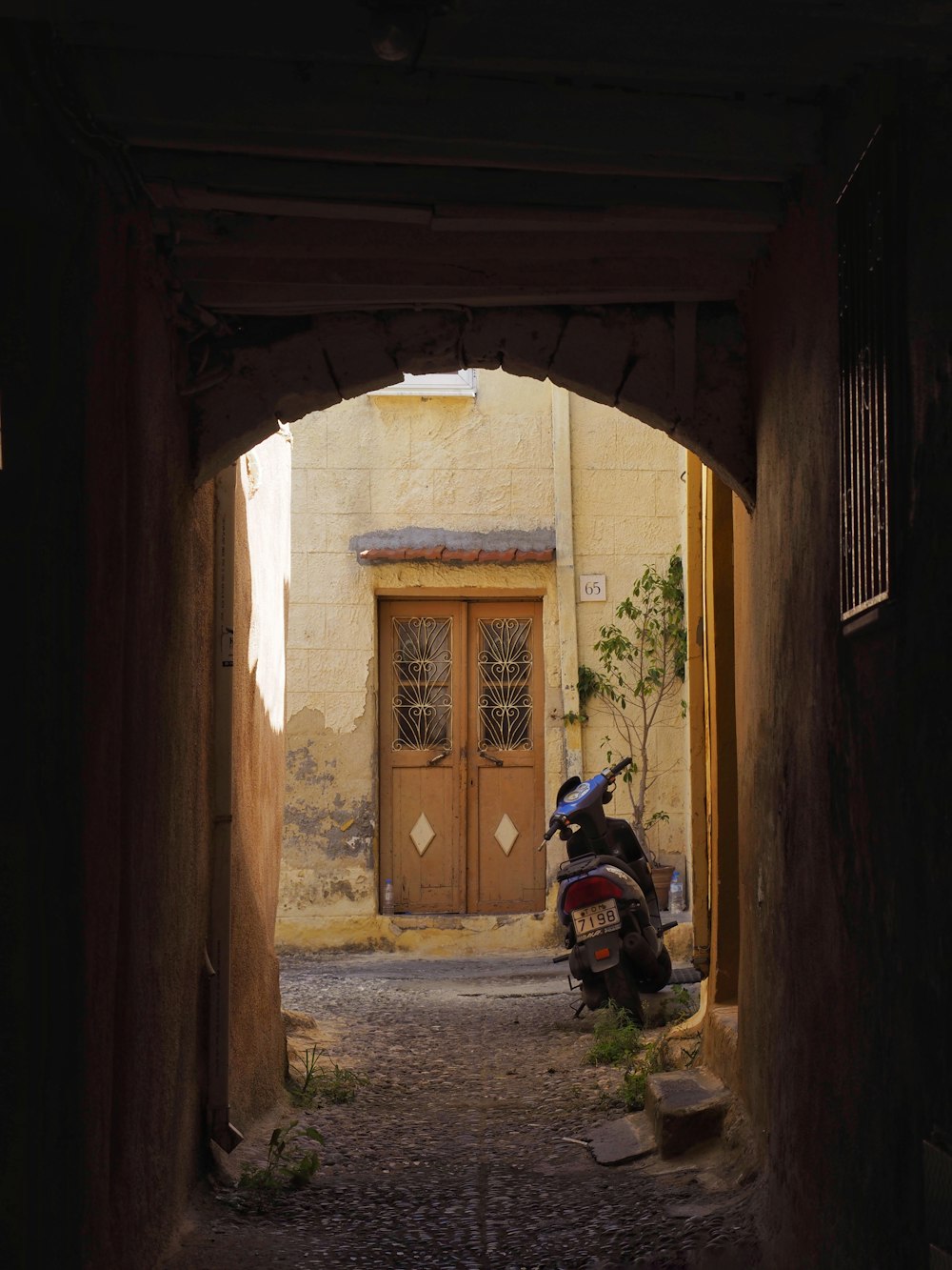 a motorcycle parked in an alley between two buildings