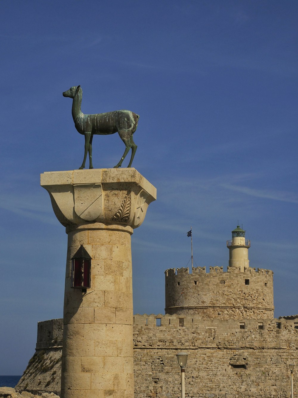 a statue of a goat on top of a tower