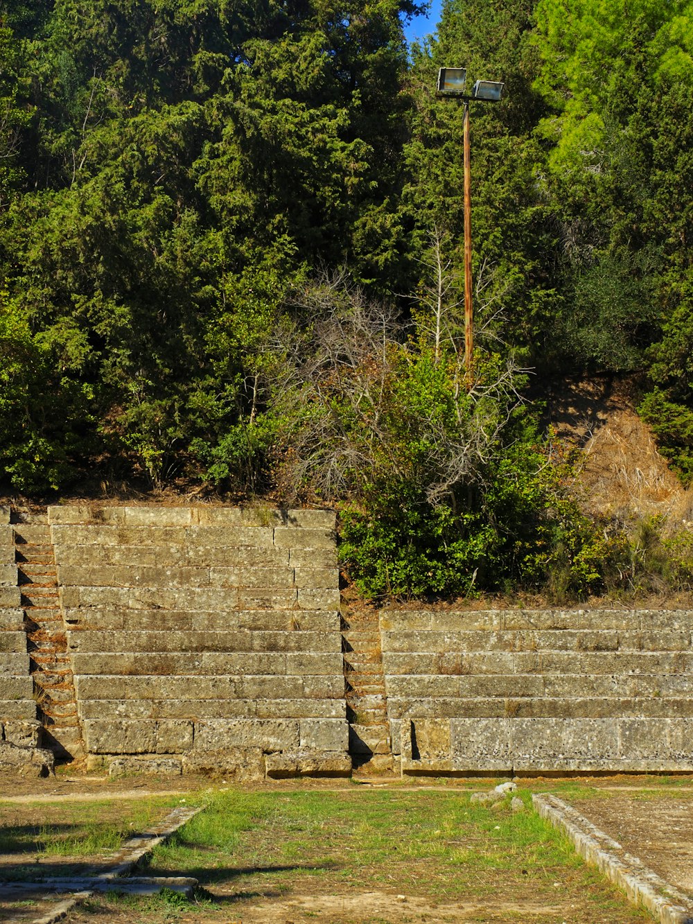 a man riding a skateboard on top of a stone wall