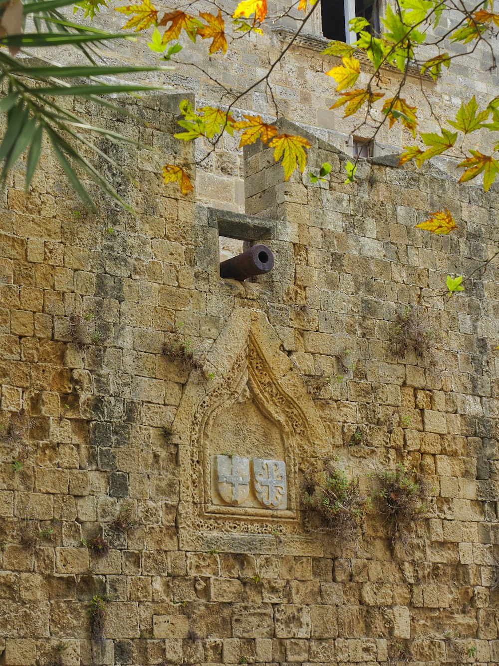 a stone building with a clock on the side of it