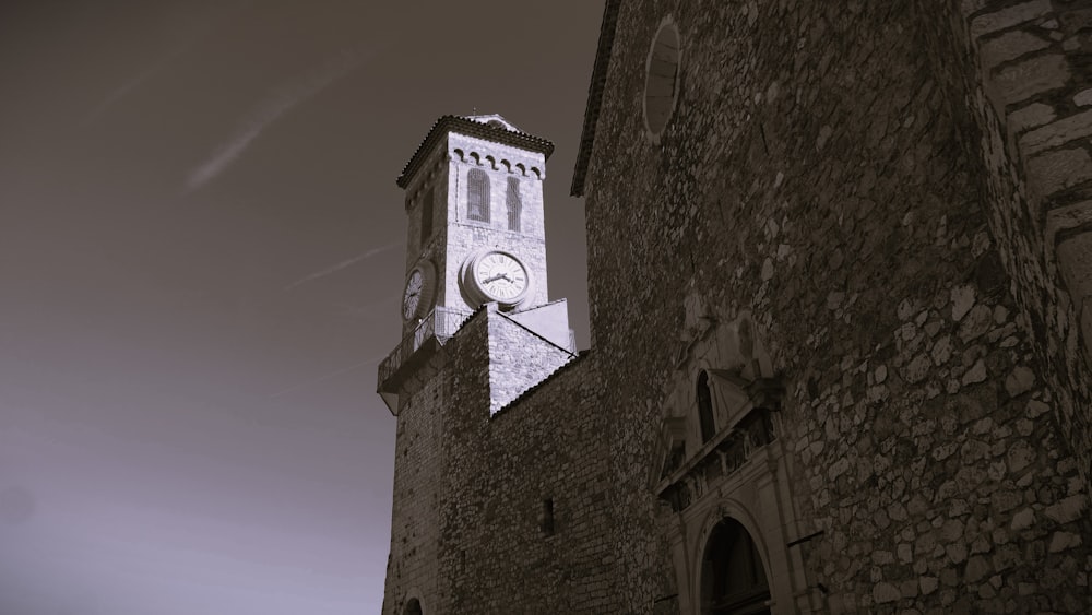 a clock on the side of a stone building