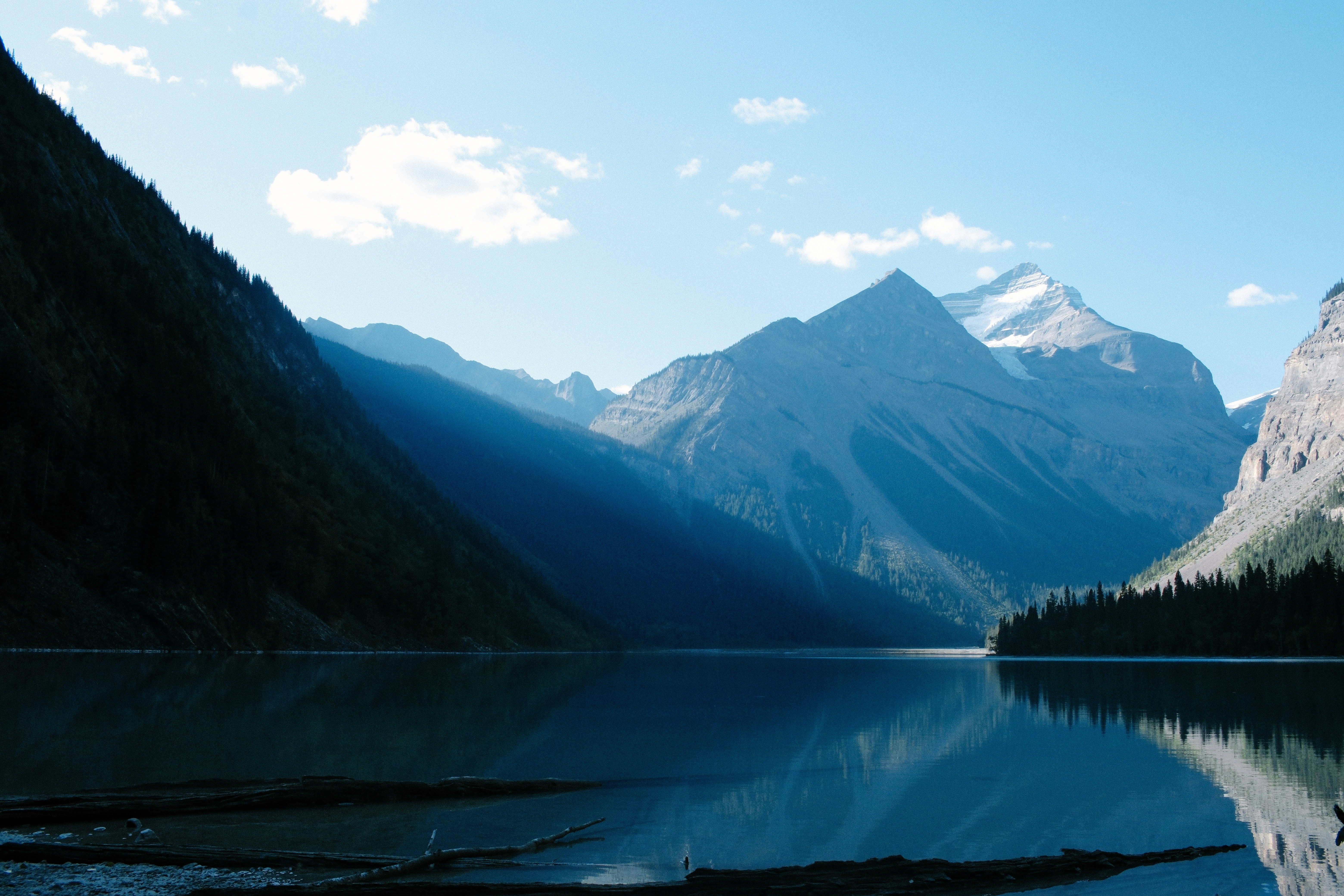 a mountain range is reflected in a still lake