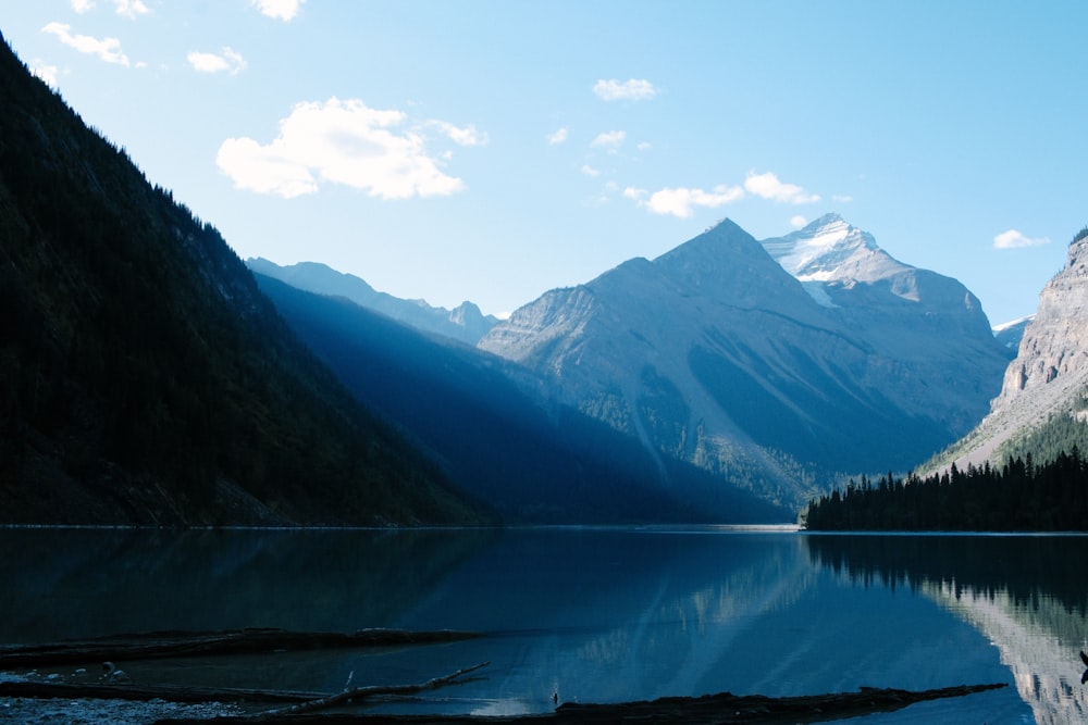 a mountain range is reflected in a still lake