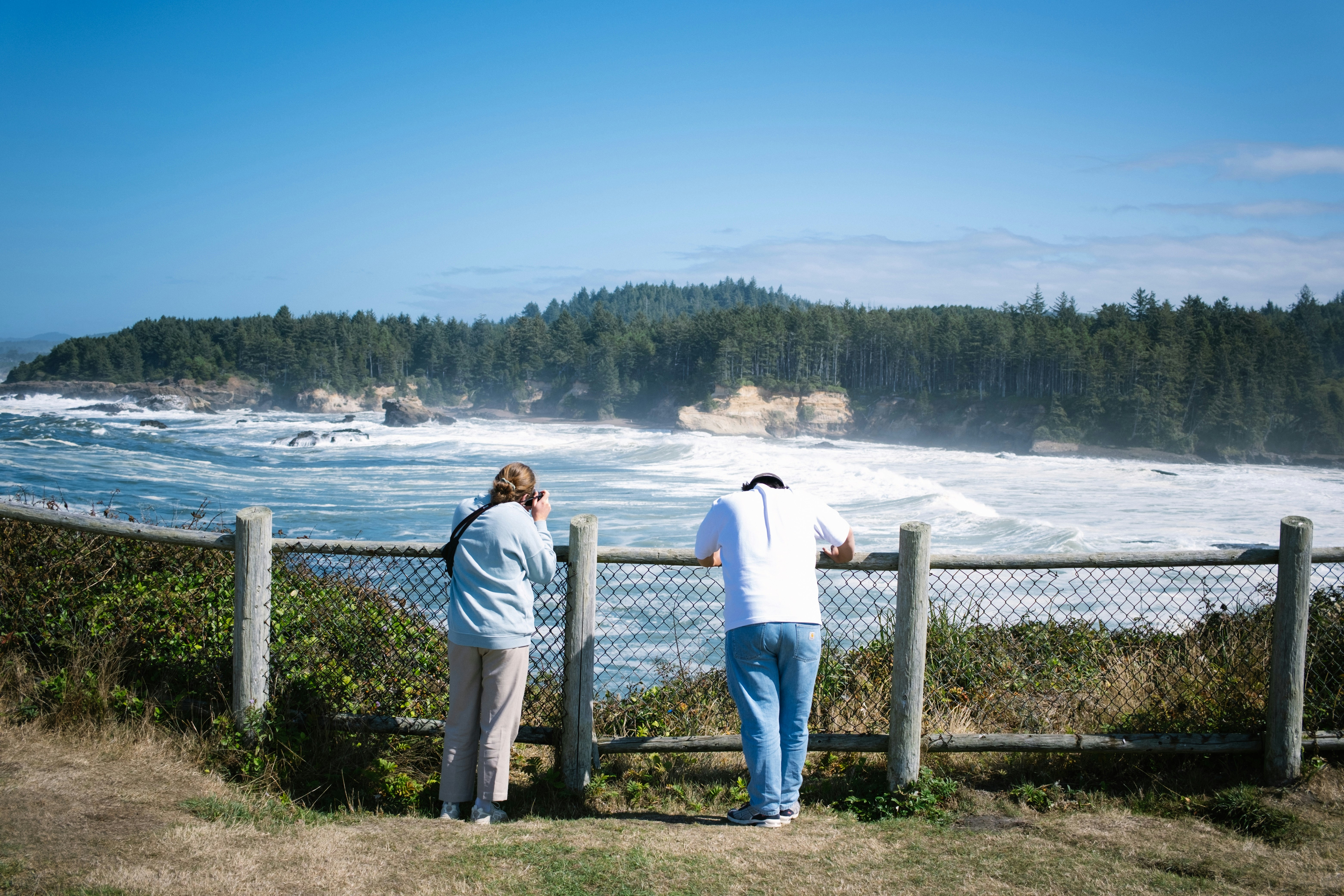 a couple of people that are looking at the water