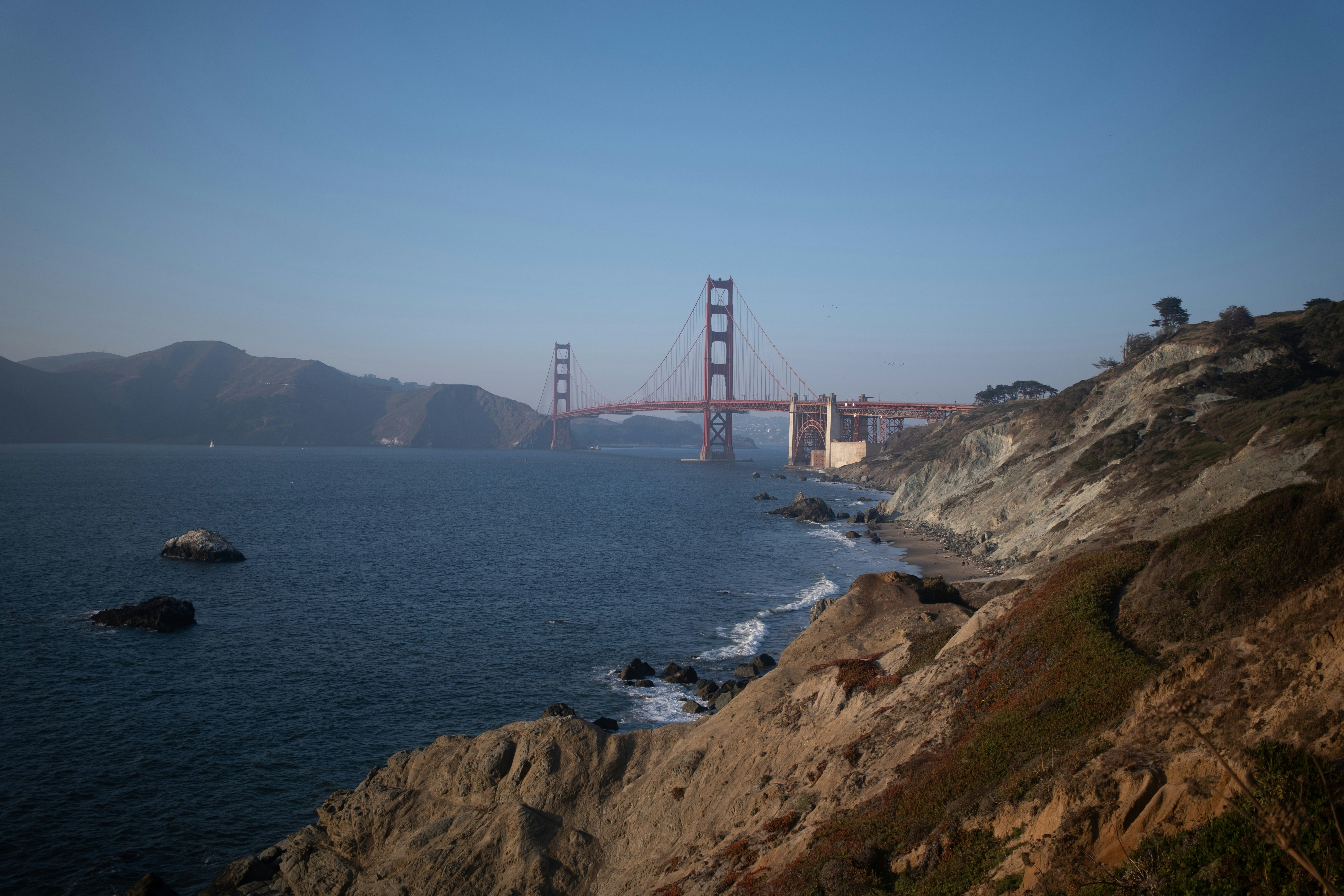 a view of the golden gate bridge from a cliff