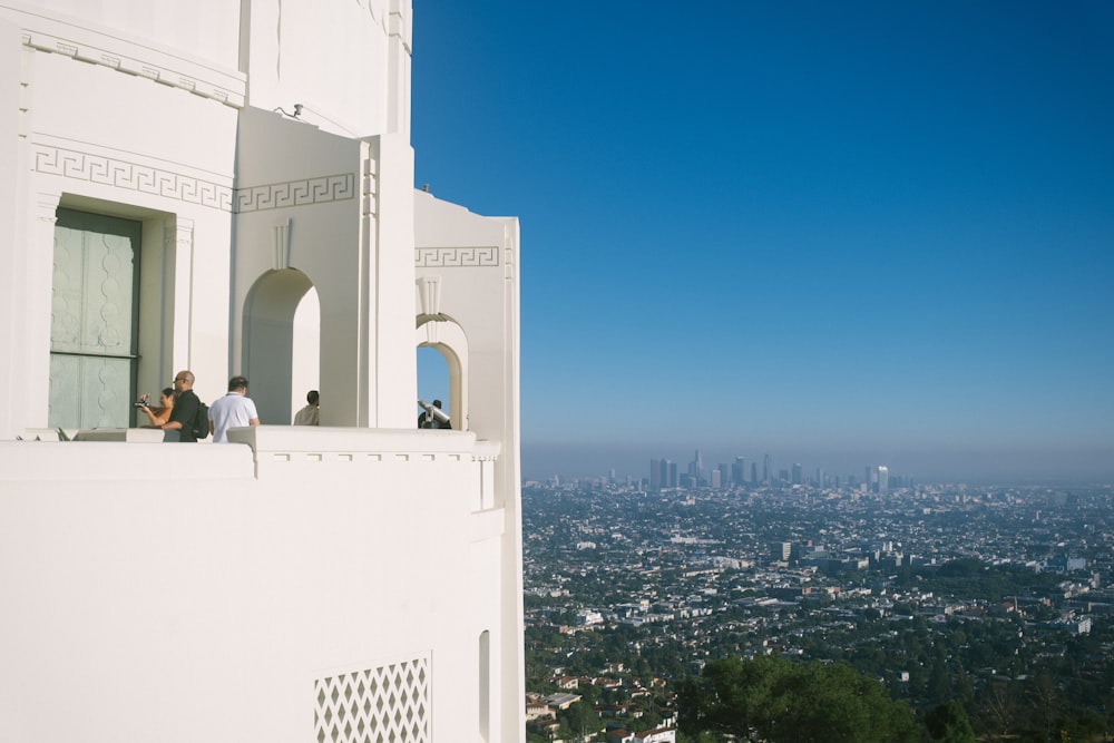 a couple of people that are standing on a balcony