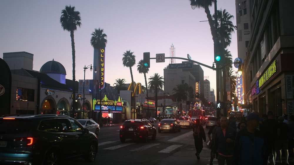 a city street filled with lots of traffic next to tall buildings