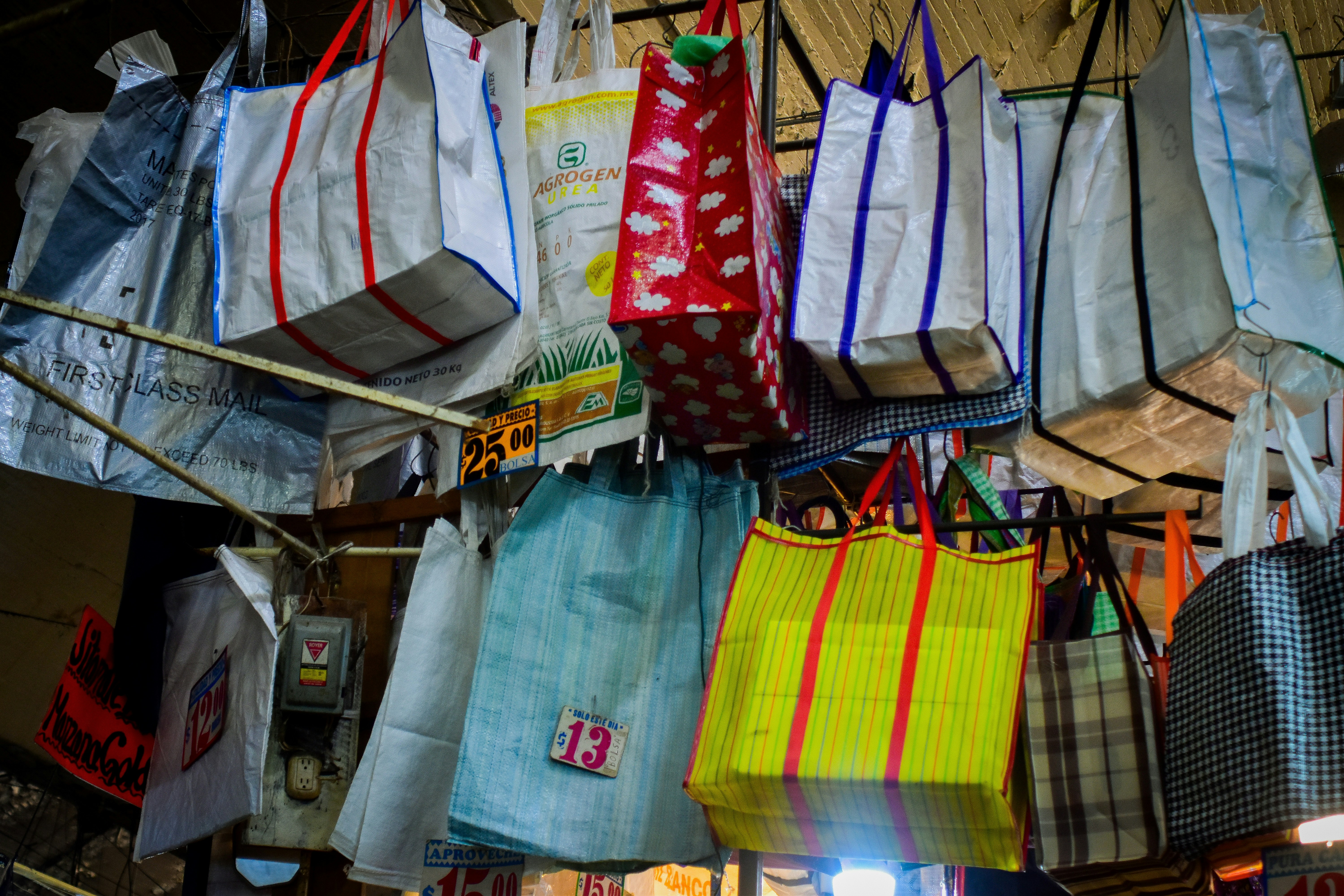 Shopping bags hanging from a ceiling