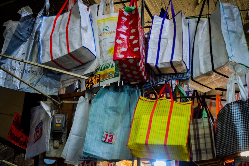 a bunch of bags hanging from a ceiling