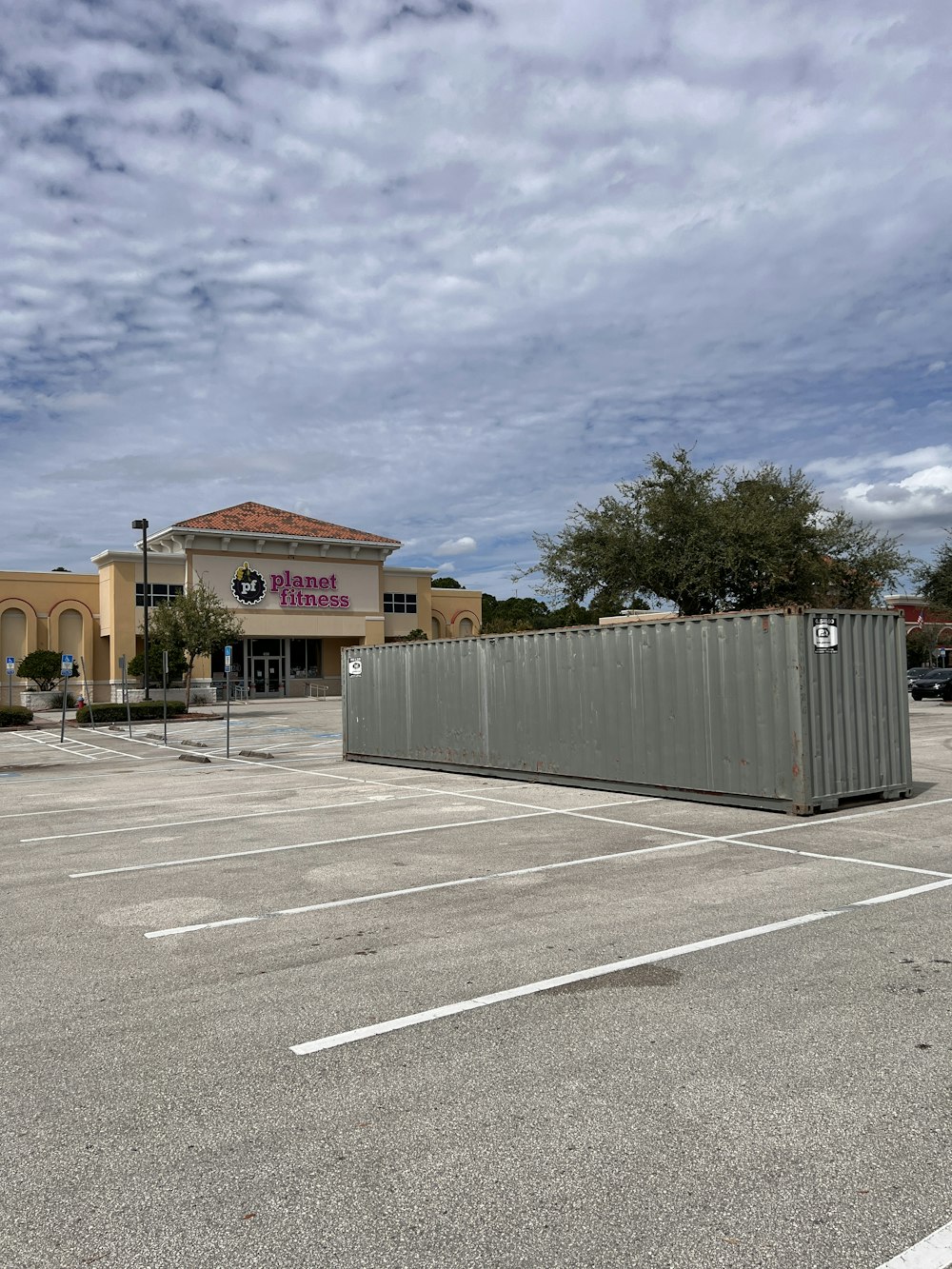 an empty parking lot with a building in the background