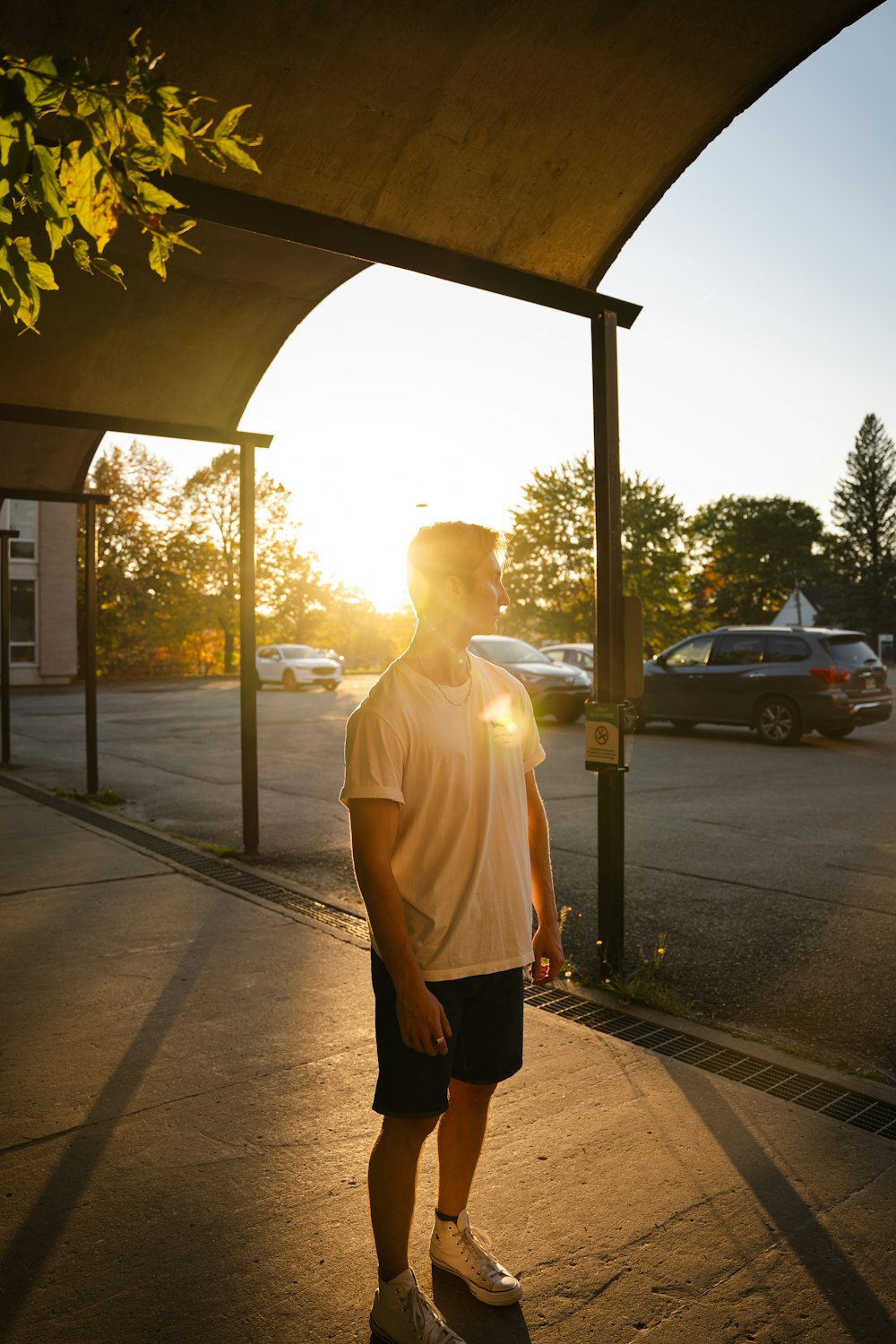 a man standing on a skateboard in a parking lot