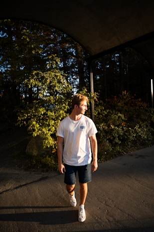 A man wearing a lightweight summer t-shirt in an outdoor setting.