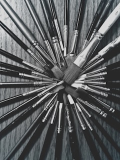 a bunch of brushes sitting on top of a wooden table