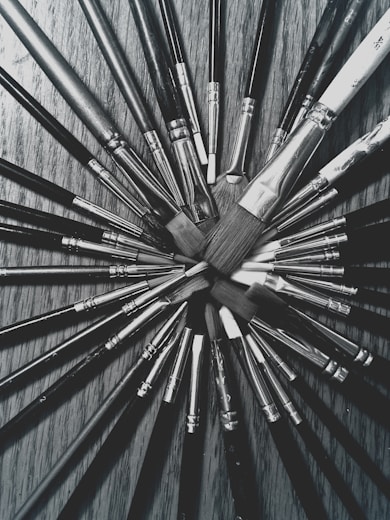 a bunch of brushes sitting on top of a wooden table
