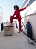A model poses confidently on a D.C. marina dock wearing a crisp District Beach linen blazer and joggers.
