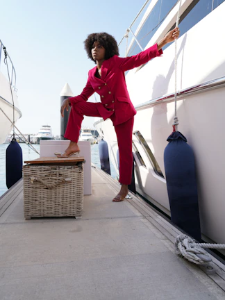A model poses confidently on a D.C. marina dock wearing a crisp District Beach linen blazer and joggers.