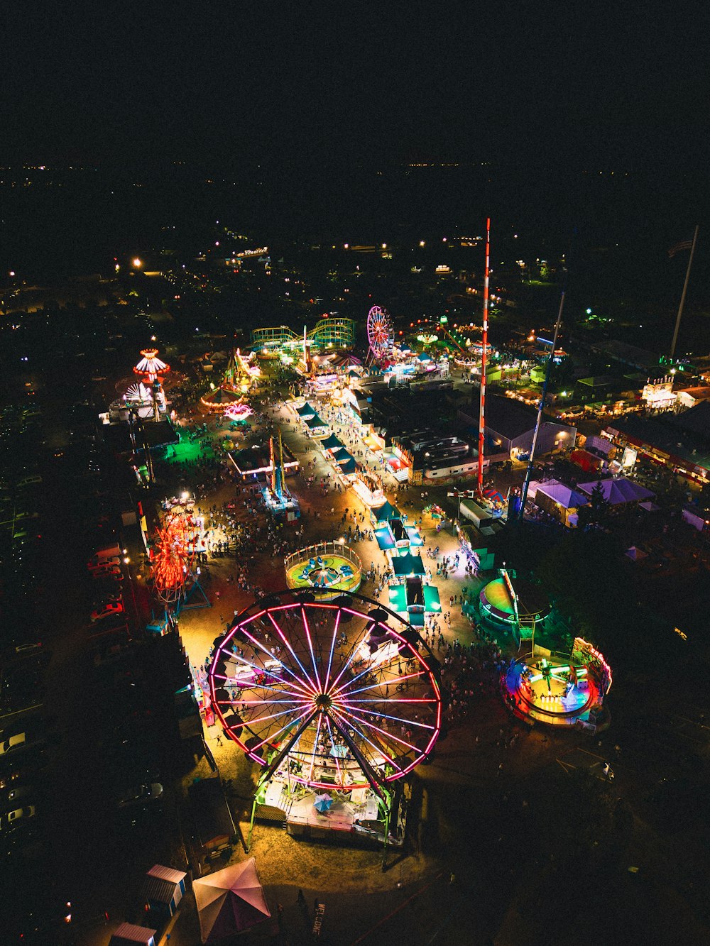 an aerial view of a carnival at night