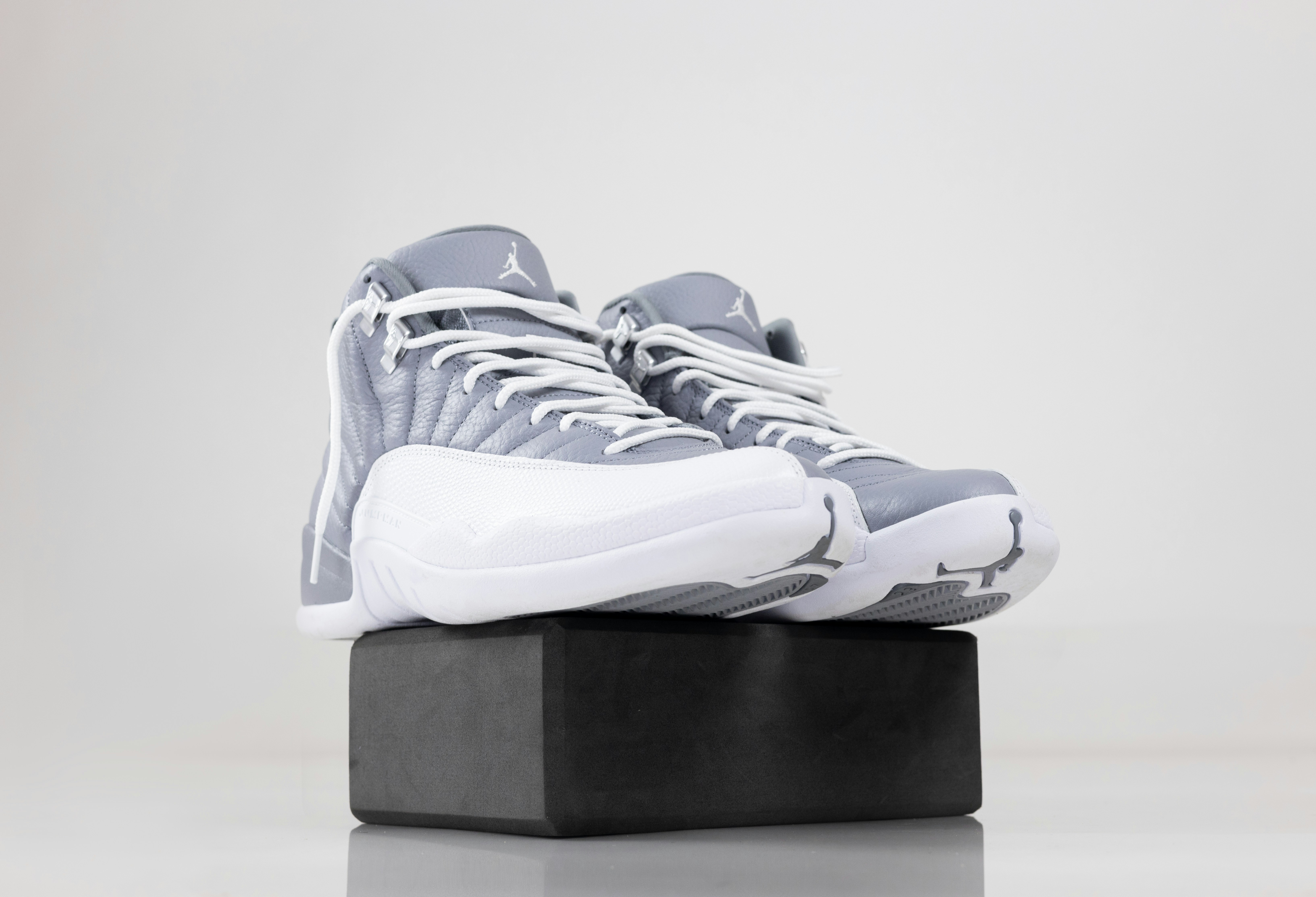 a pair of sneakers sitting on top of a black block