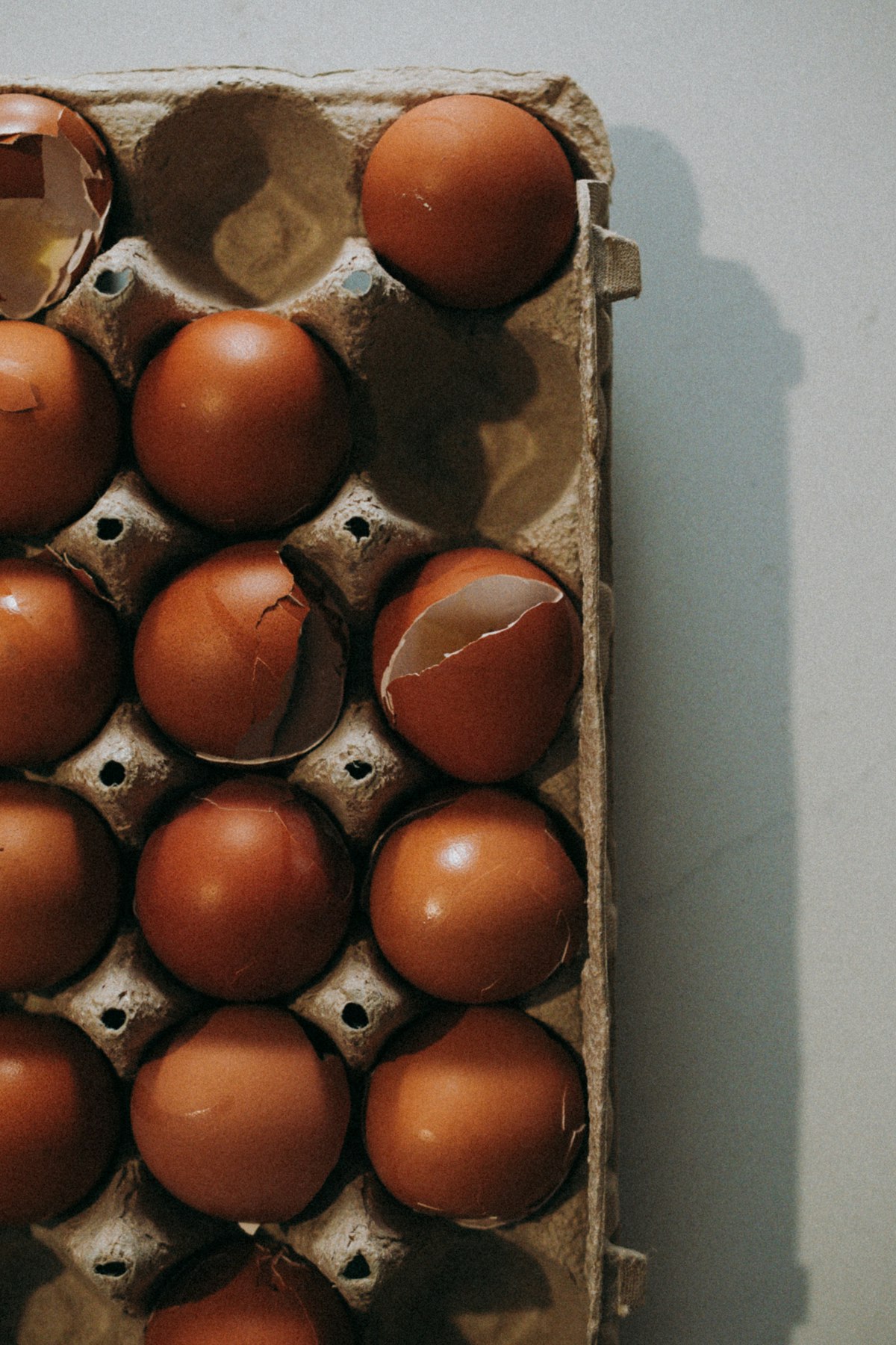 Brown eggs in a carton on a kitchen table