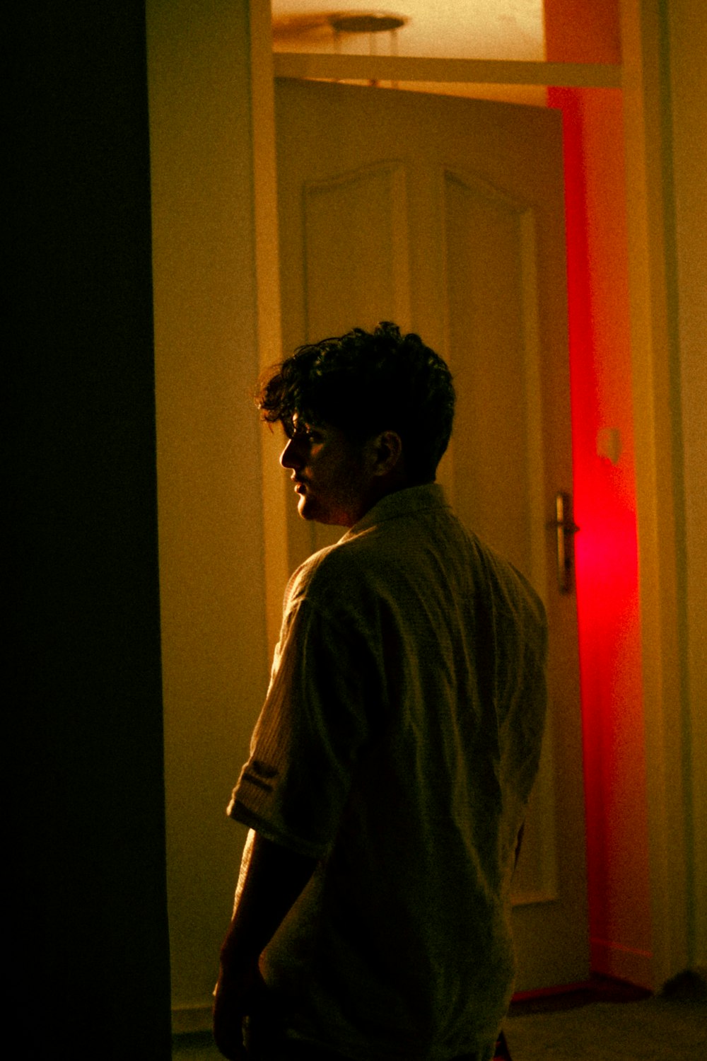 a person standing in a room with a light on