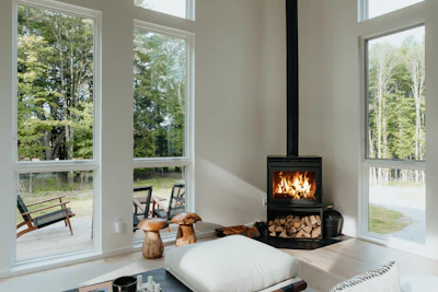 Cozy modern fireplace with natural wood accents in a living room.