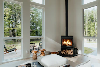 a living room with a fire place in the middle of it
