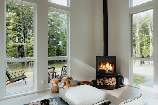 Cozy Scandinavian-style living room bathed in soft infrared glow with natural wood textures and warm sunlight.
