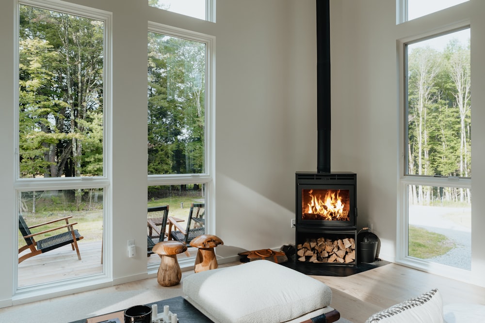 a living room with a fire place in the middle of it