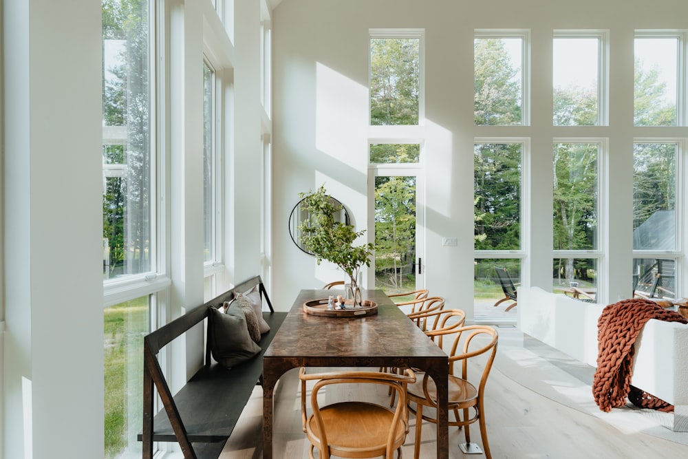 a dining room with a long table and lots of windows