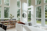 a living room filled with furniture and lots of windows