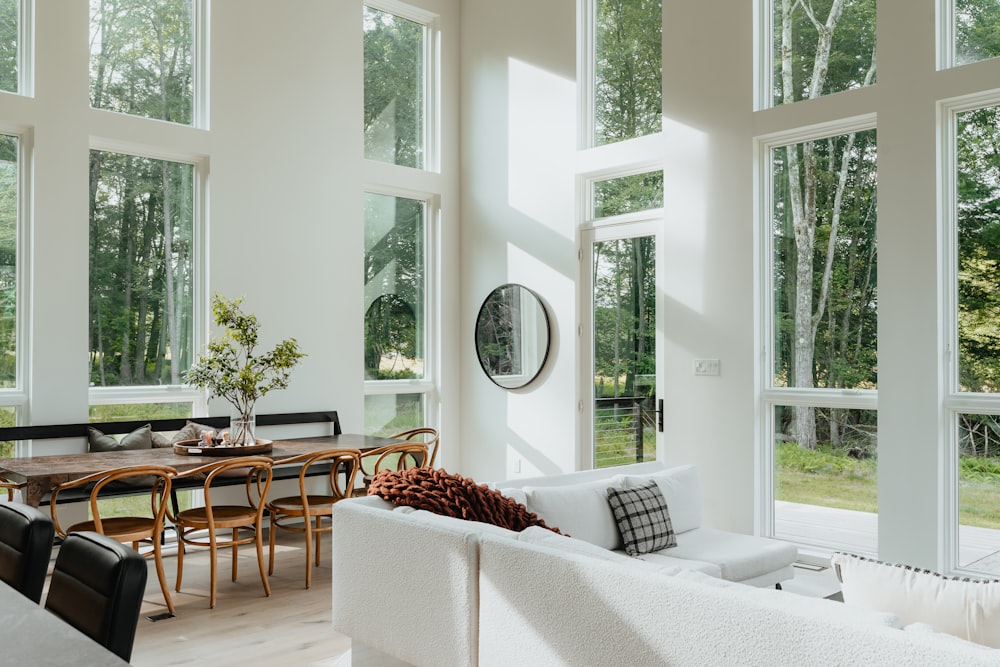 a living room filled with furniture and lots of windows