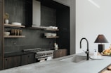 a kitchen with a sink and a stove top oven
