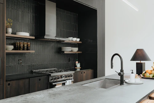 a kitchen with a sink and a stove top oven