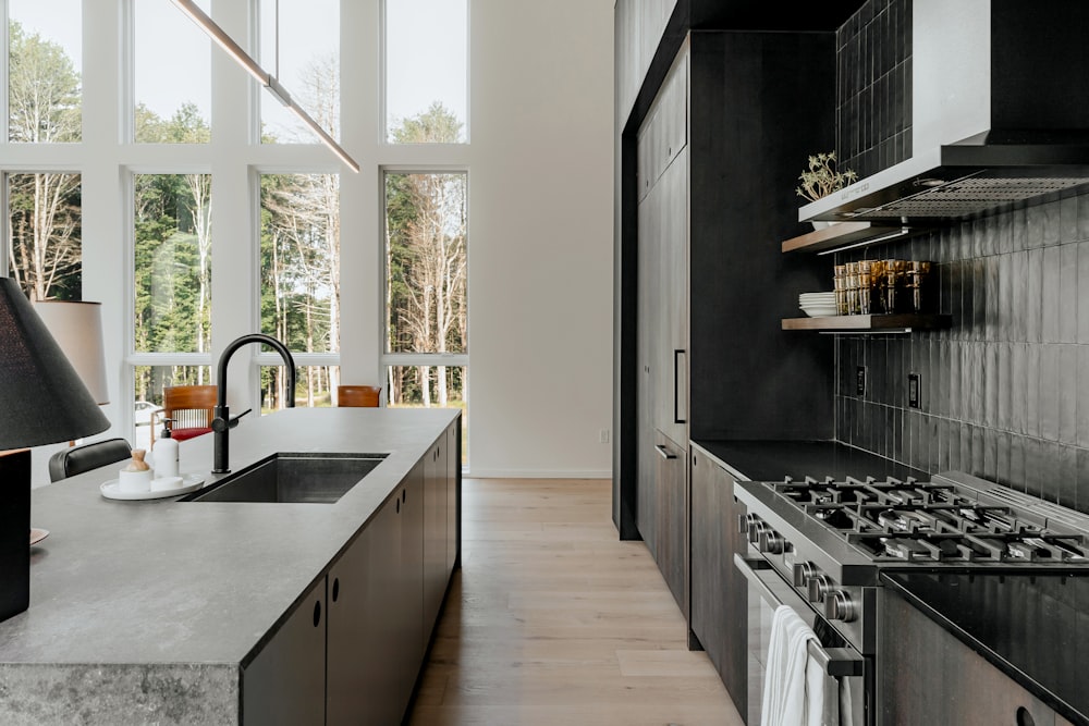 a kitchen with a stove top oven next to a window