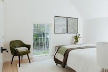 a bedroom with a bed and a chair in it