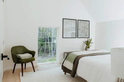 Minimalist bedroom featuring green plants and natural wood accents.