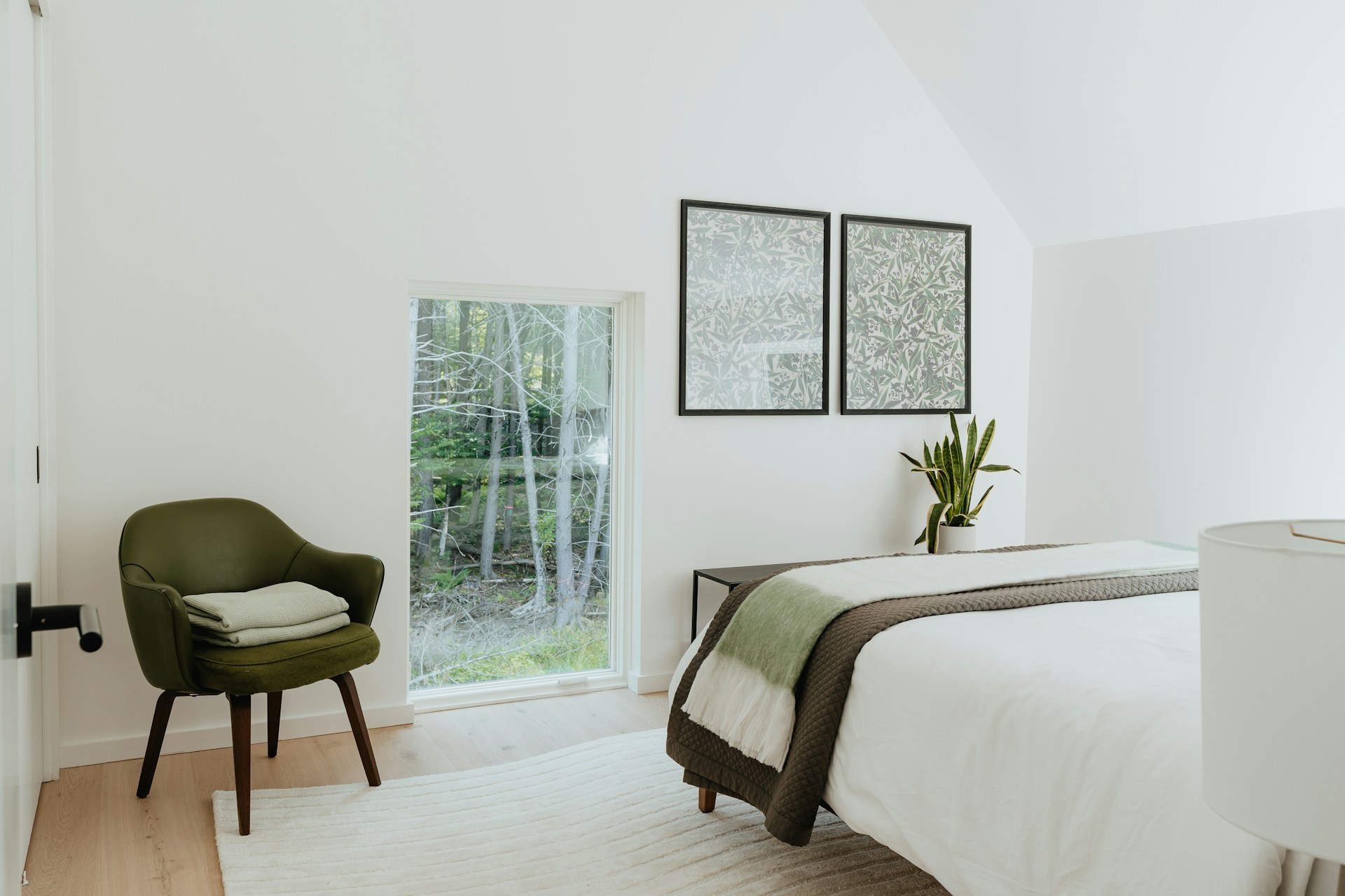 a bedroom with a bed and a chair in it