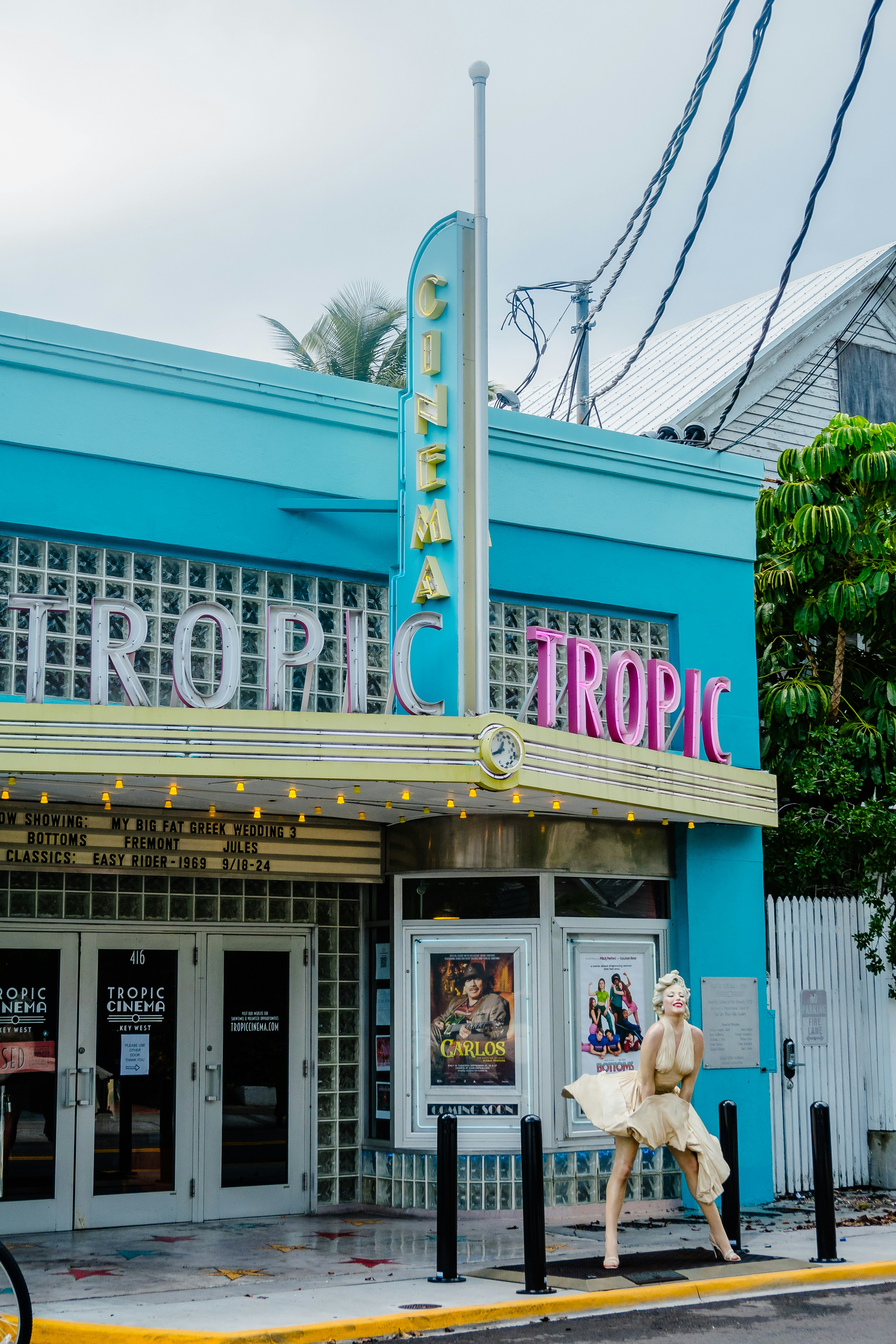 a movie theater with a sign that says tropic