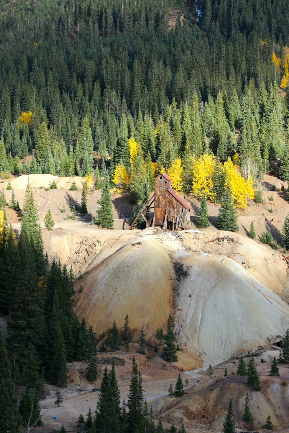 an old building on top of a hill surrounded by trees