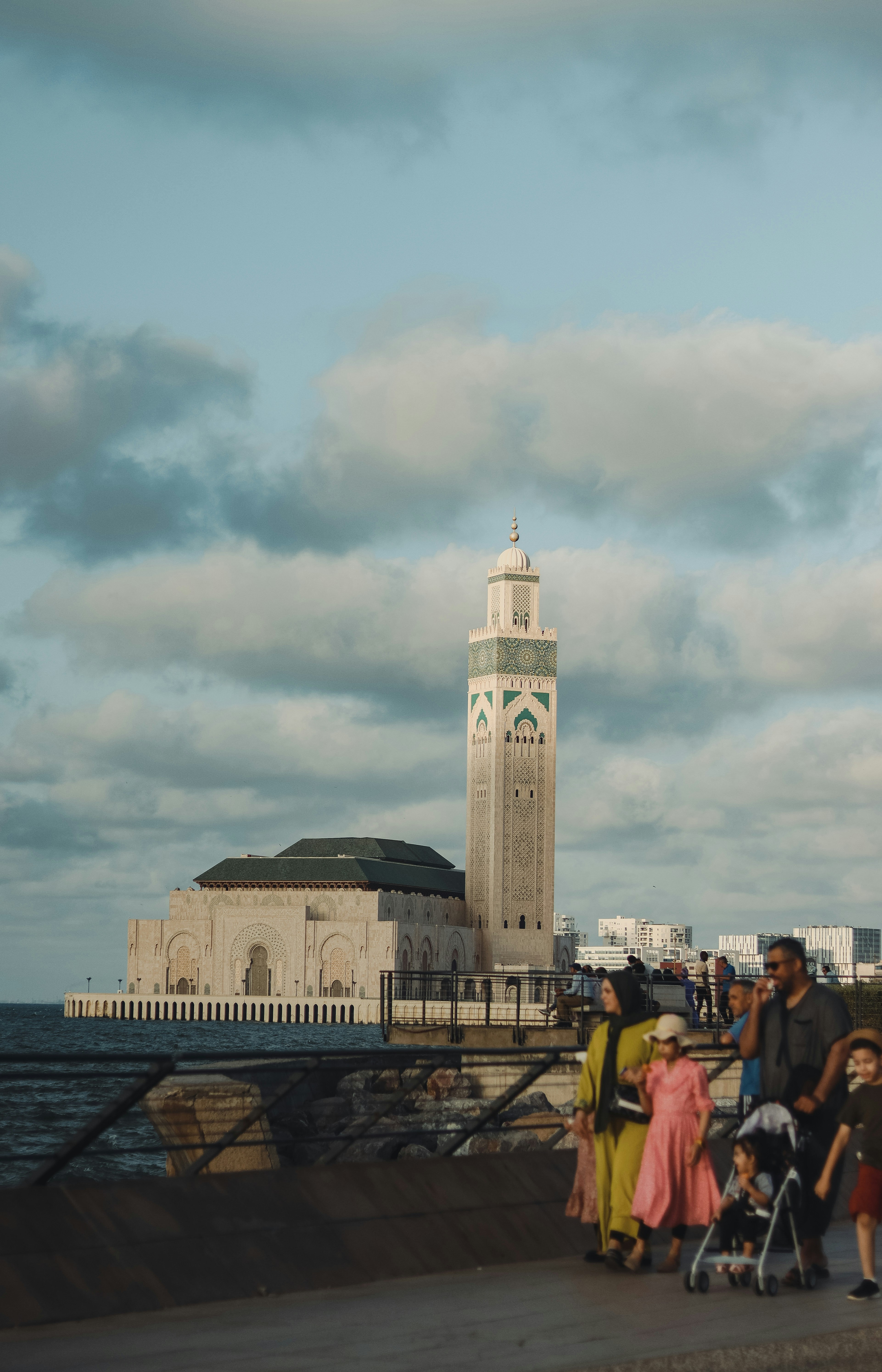 a group of people standing next to a body of water
